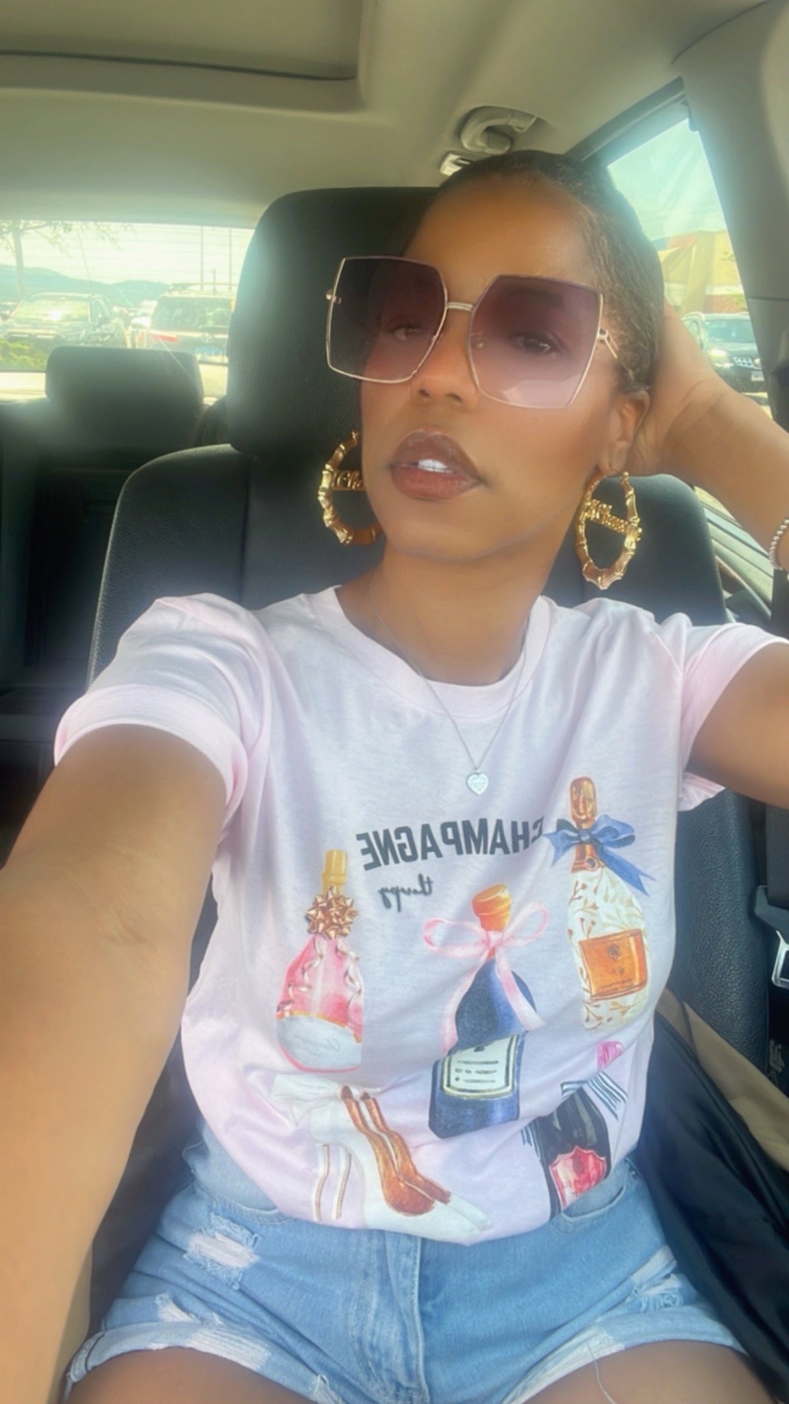 Sitting in a car wearing a graphic t-shirt and sunglasses #lovechampange